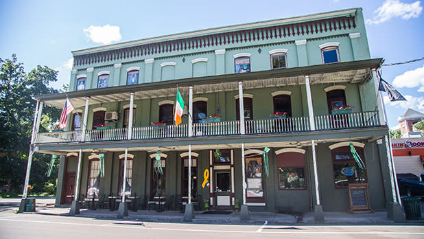 American and Irish flags hang outside the 1867 Parkview Inn