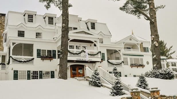Exterior of the Mirror Lake Inn decorated for the holidays and covered in snow