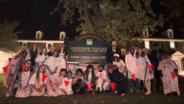 Scare actors outside the “Survive the Sanatorium” Haunted House on Genesee Valley Council on the Arts' Murray Hill Campus.