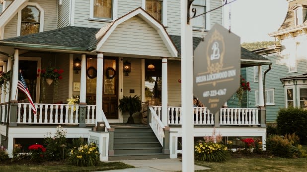 A sign hangs on a wooden post outside the historic Belva Lockwood Inn