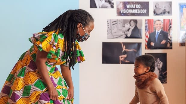 A woman dances with a young child during the Black Future Festival at the Brooklyn Children's Museum