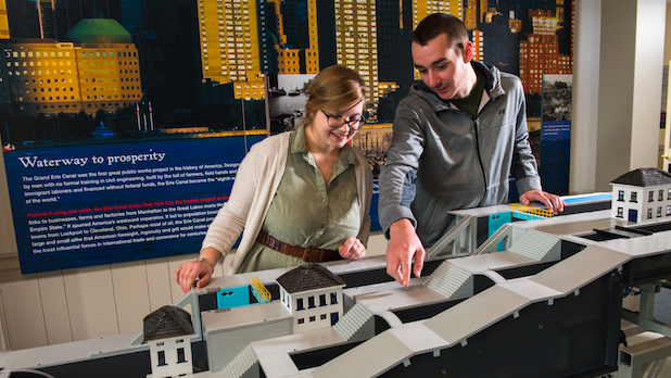 two people interactive with an exhibit at the Erie Canal Discovery Center