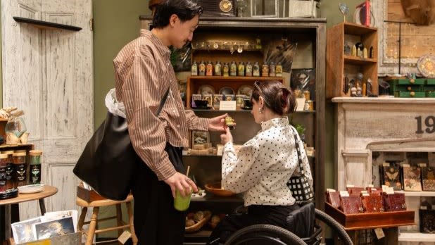 A woman in a wheelchair and a man check out trinkets and other items at Finders Keepers in Beacon