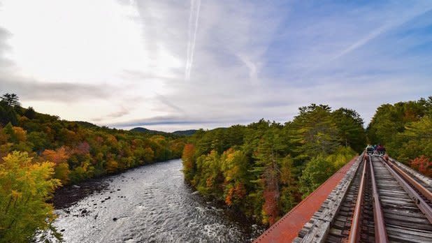 View from a rail bike pedaling on railraod tracks on a bridge over a river
