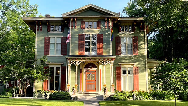 The green and red exterior of the Landmark Inn, an 1856 Italianate mansion turned bed and breakfast