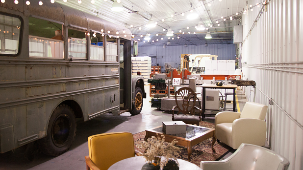 String lights hang from the ceiling above a bus inside the taproom at Awestruck Cider