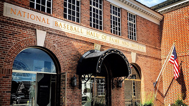 An American flag waves in front of the National Baseball Hall of Fame and Museum in Cooperstown