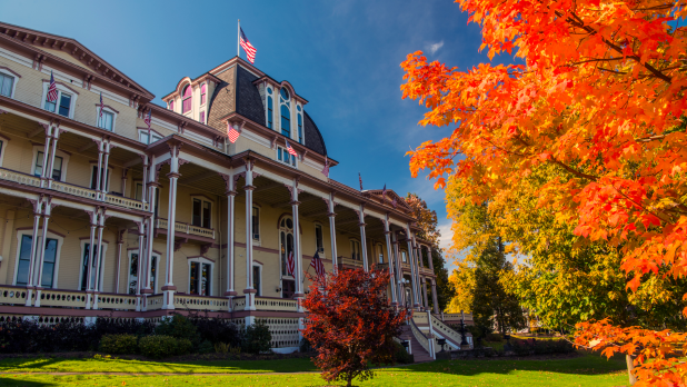 Exterior of the Athenaeum Hotel surrounded by fall foliage at the Chautauqua Institution