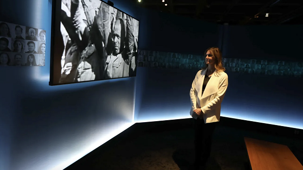 Andrea Winograd stands before an exhibit at the Holocaust Museum & Center for Tolerance and Education