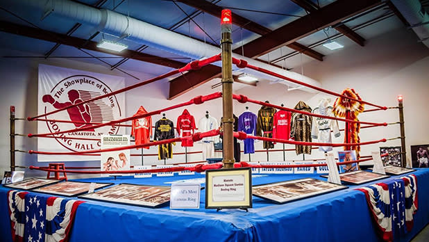 An exhibit showcasing a boxing rings, robes and other memorabilia at the International Boxing Hall of Fame.
