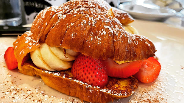 A croissant French toast stuffed with strawberries and bananas at Maureen's Kitchen