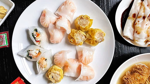 A white plate filled with a variety of dim sum and dumplings