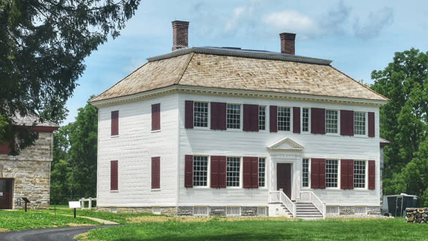 White house with red shutters at Johnson Hall Historic Site.