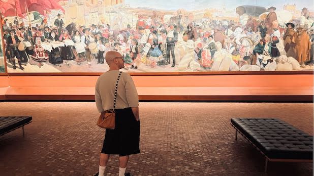 A man gazes at a painting in at the Hispanic Society Museum and Library