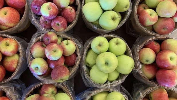 Baskets of green, yellow, and red apples