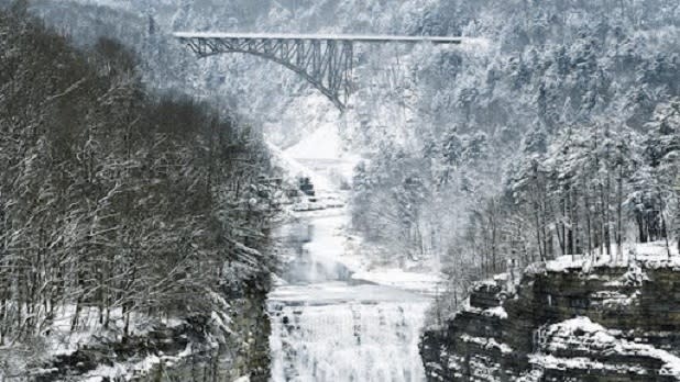 Waterfall and bridge covered in snow at  Letchworth