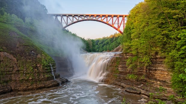 A bridge spans a rushing waterfall at Letchworth State Park