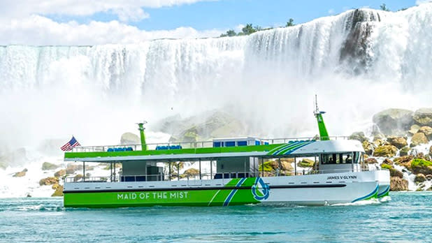 The green and white Maid of the Mist boat touring along the Niagara Falls