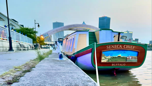 Yellow, green, and brown wood boat docked in Rochester at sunrise