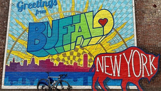 A colorful mural that says "Greetings from Buffalo" with the words "New York" written on a red buffalo