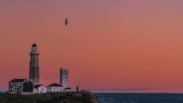 Orange winter sunset behind the Montauk Lighthouse