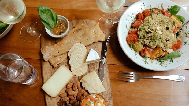 A fancy lunchtime spread of white wine, crackers, cheese, and almonds at Moosewood Restaurant along with a couscous salad