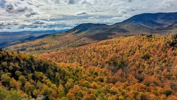 View form the Owl Head Lookout looking out at the Adirondack Mountains spotted with fall colors