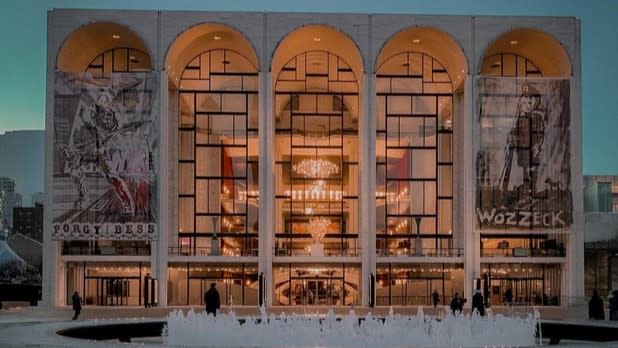 The exterior of the New York Opera House illuminated at night