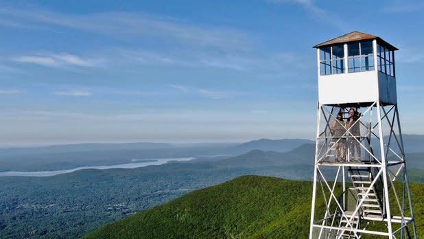 View of the Overlook Mountain Fire Tower and sprawling Catskills Mountains from above on a getaway to the Catskills