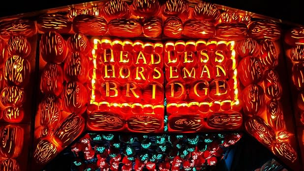 The "Headless Horseman Bridge" made of intricately carved jack o'lanterns welcomes guests at the Great Jack O'Lantern Blaze