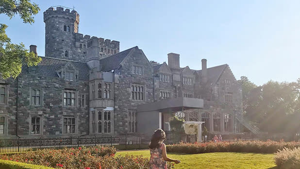 A woman walks along the grounds of the Sands Point Preserve near one of the grand estates