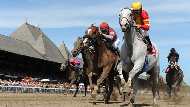 Action shot of a group of jockeys and horses competing at Saratoga Race Course