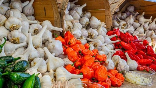 White garlic and other vegetables spill out of buckets