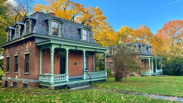 Quaint cottages surrounded by beautiful fall foliage at Snug Harbor Cultural Center & Botanical Garden