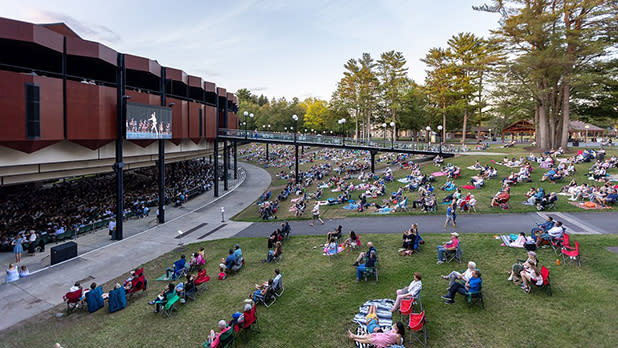 People gather on the lawn to enjoy a concert at the Saratoga Performing Arts Center