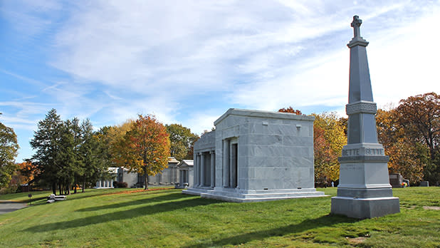 Mausoleums stand on a hill amid fall foliage at Historic St. Agnes Cemetery in Albany