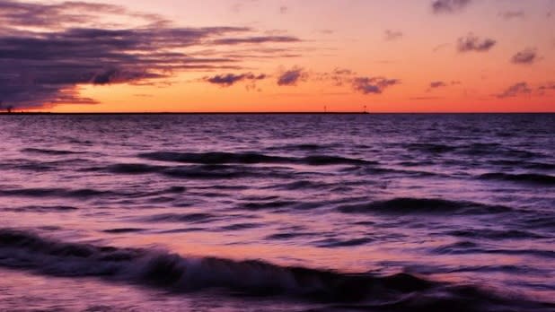 Orange sunset reflecting over the Lake Ontario waters