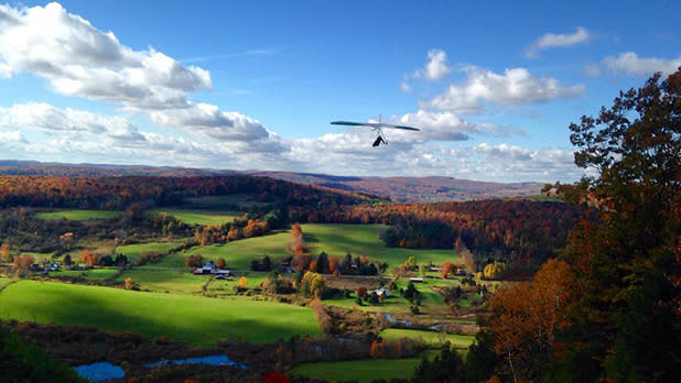 Hang gliding at Susquehanna Flight Park across the green hills and surrounding fall foliage