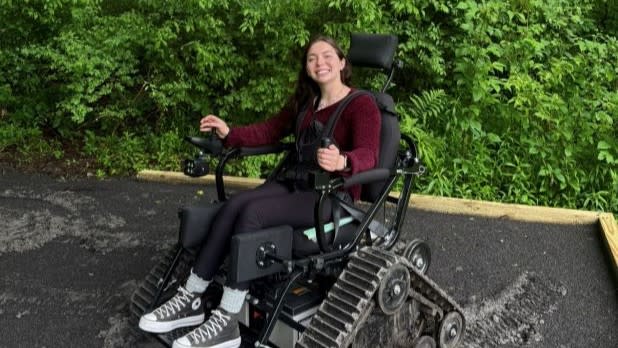 Tara Shetterly smiling in an Action TrackChair at Lime Hollow Nature Preserve in the Finger Lakes
