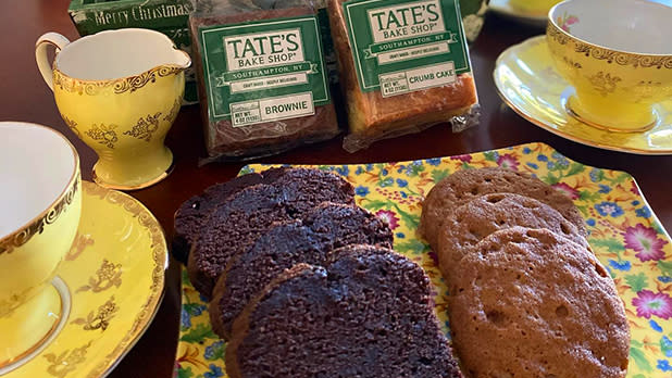 A display at Tate's Bake Shop featuring a yellow tea set, cookies, brownies, and crumb cake