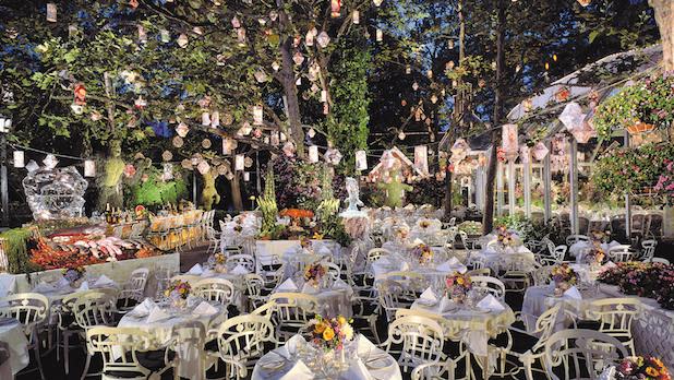 White tables and chairs underneath dangling lights in the Crystal Garden at Tavern on the Green in Central Park.
