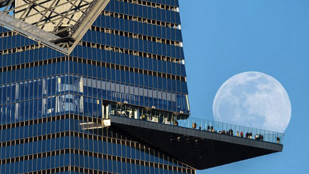 The moon behind the outdoor skydeck at the Edge NYC