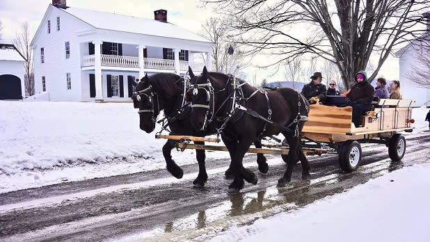 A horse-drawn carriage ride as snow falls at the Farmers' Museum
