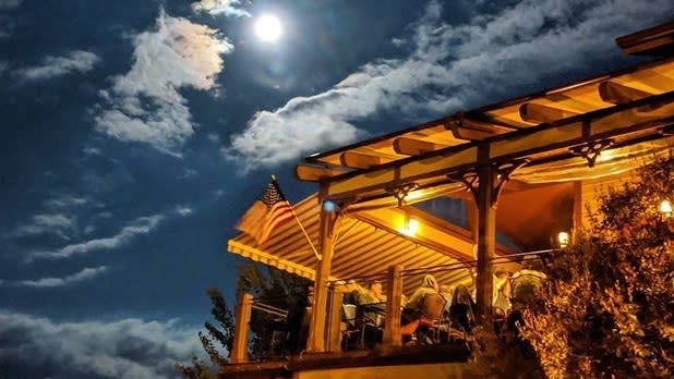 View looking up at an outdoor patio illuminated by moonlight