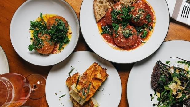 A view looking down at four plates of food