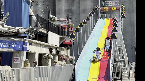 kids slide down a vibrantly-colored slide at Buffalo Riverworks