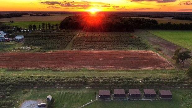 The sunset over the sprawling fields and vineyards at Becker Farms
