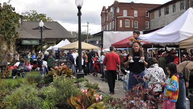 People stroll through tents and vendors at the Warwick Applefest