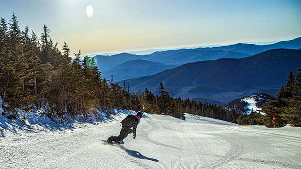 A person skies down Whiteface Mountain on a bright winter day