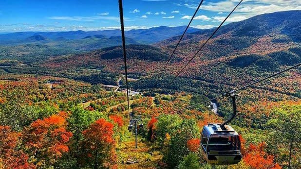 View of Whiteface Mountain and surrounding Adirondack Mountains with fall colors from a gondola